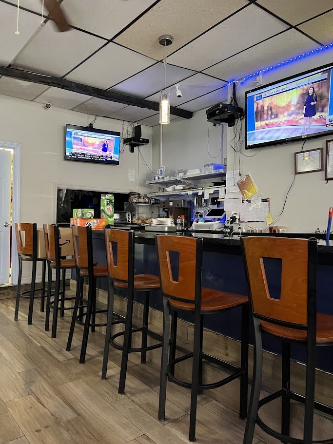 Buffet counter with warm serving trays and overhead lights.